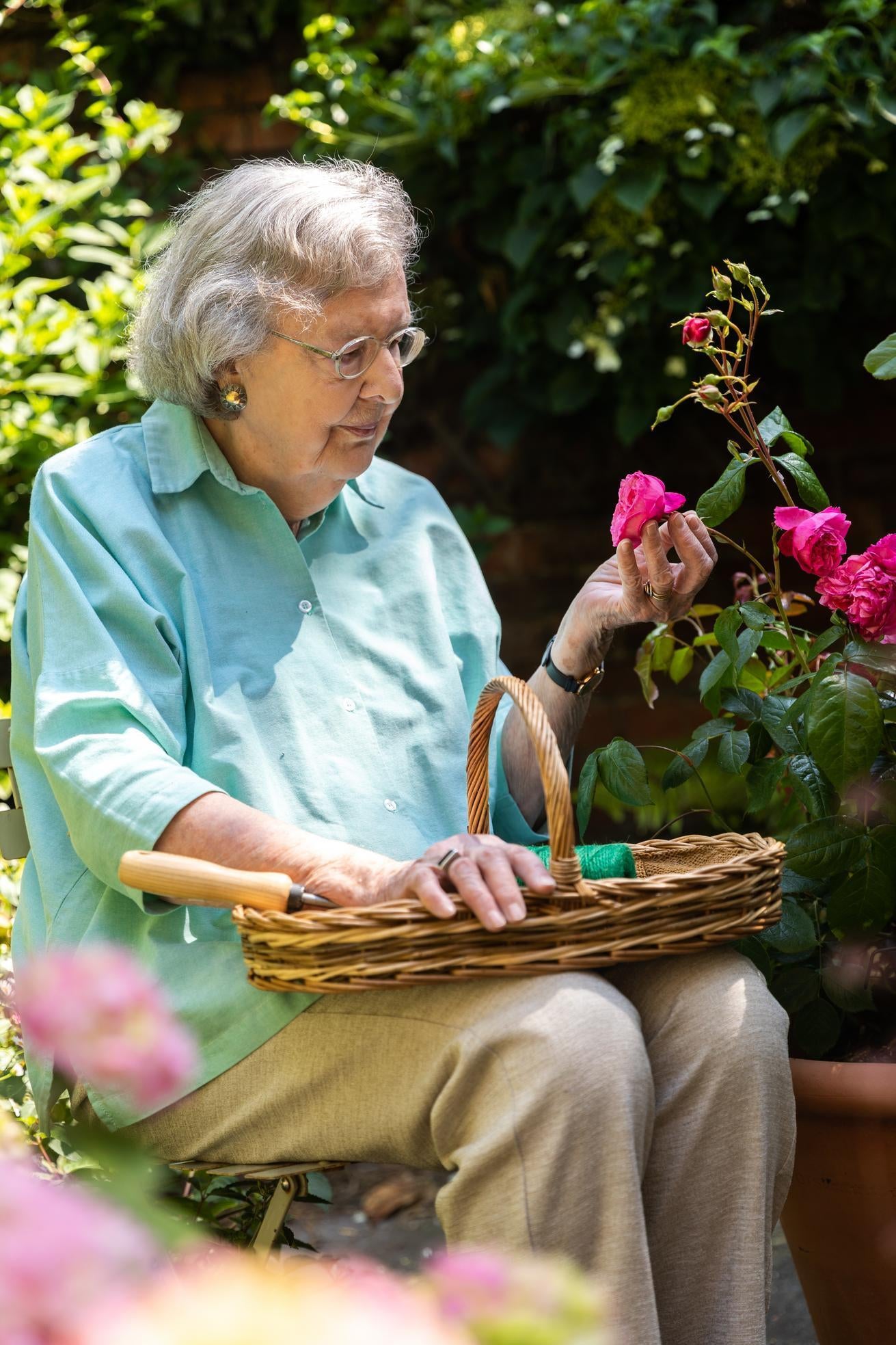 Penelope_Lively author with a pink rose bred by David Austin